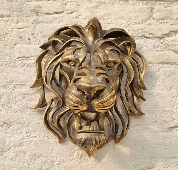 Strong metal lion head sculpture, an elegant animal art piece for sophisticated wall decor.