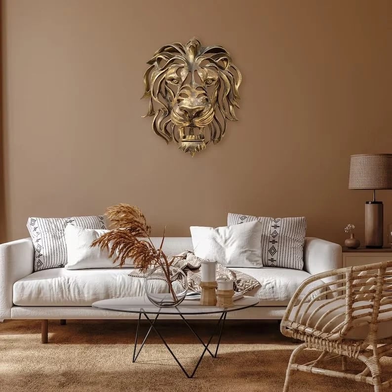 Handcrafted metal lion head wall decor, an impactful animal art sculpture adding strength & elegance to your home.