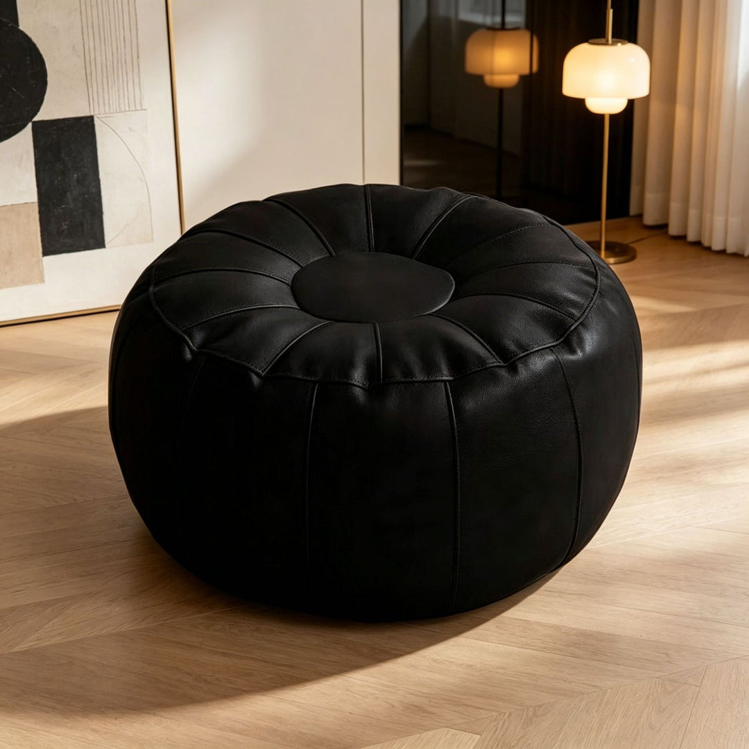 Comfortable modern round footrest stool, elegant design for living room. Stylish contemporary accent furniture.