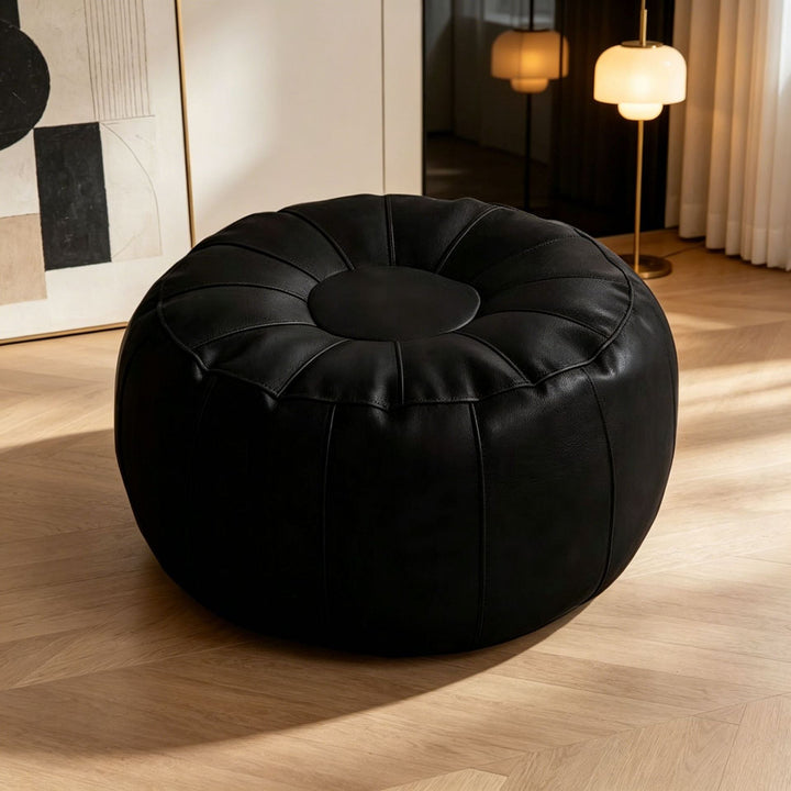 Comfortable modern round footrest stool, elegant design for living room. Stylish contemporary accent furniture.
