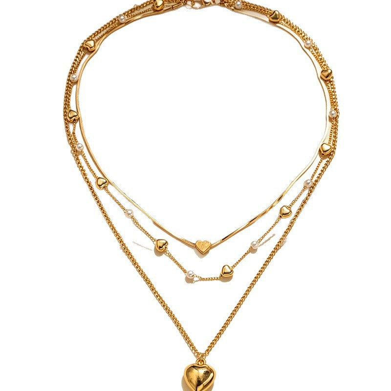 Chic women's multi-layer heart pendant necklace, a trendy fashion jewelry accessory for any elegant outfit.