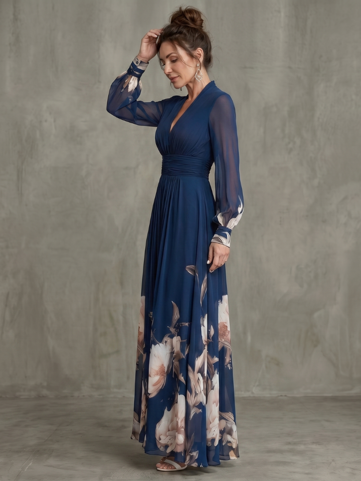 Women's sophisticated navy maxi dress with elegant print, sheer sleeves, & plunge neck. Ideal for formal events.