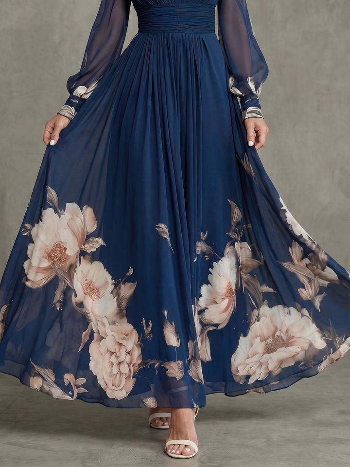 Flowy printed maxi dress for women in navy blue, with delicate sheer sleeves & a flattering plunge neckline. Evening wear.