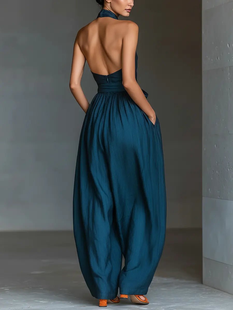 Comfortable women's halterneck wide-leg jumpsuit in navy. Flowy, with tie waist & pockets for effortless summer style.