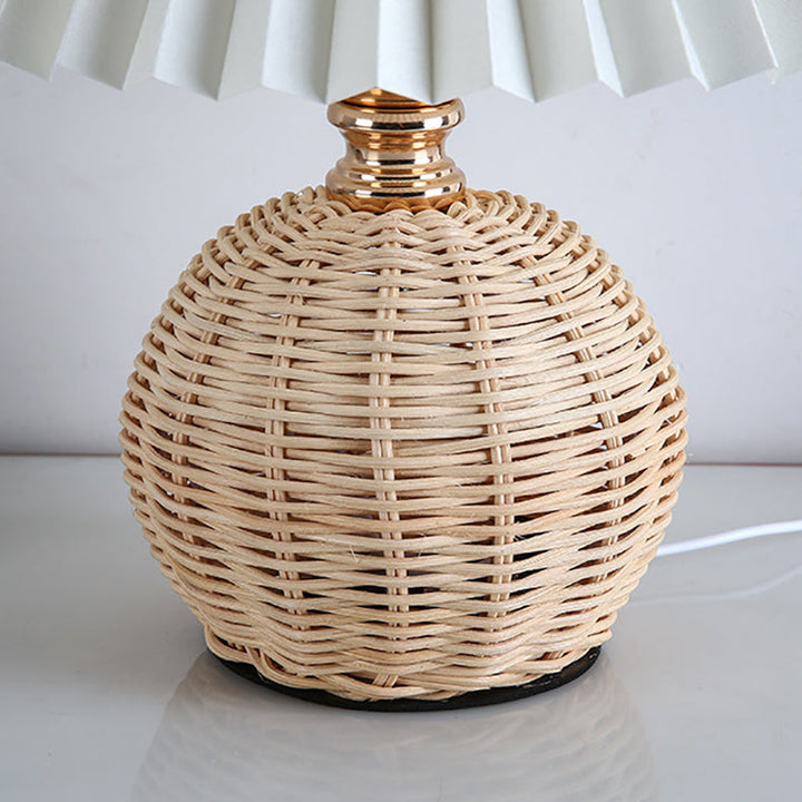Elegant Nordic rattan LED table lamp with fabric shade for modern bedroom decor.