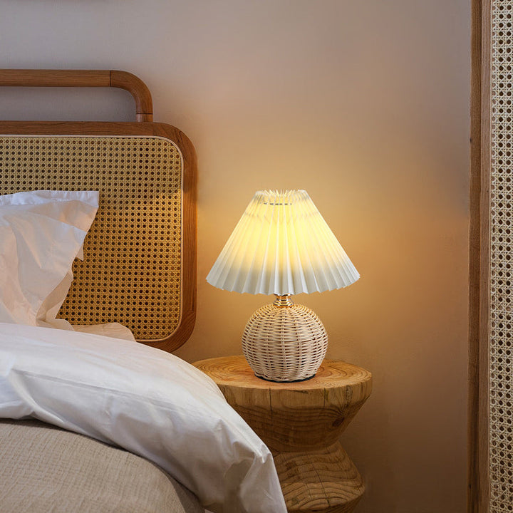 Contemporary rattan LED table lamp, elegant design for living room and bedroom ambiance.