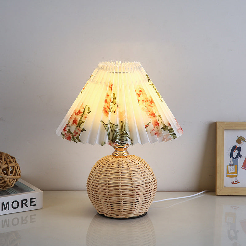 Nordic style rattan table lamp with soft LED light, ideal for cozy living room ambiance.