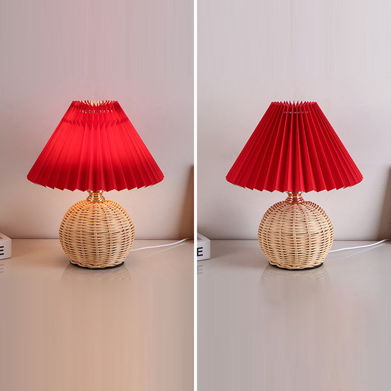 Elegant LED table lamp featuring a rattan base and fabric shade, perfect for bedrooms.