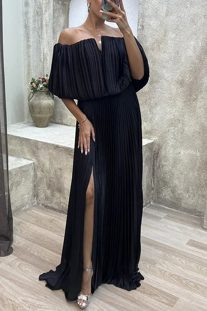 Black off-shoulder pleated statement maxi dress. Elegant evening gown for sophisticated formal events.