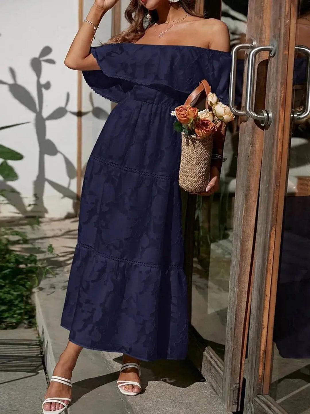 Women's flowy off-shoulder tiered maxi dress with ruffles, ideal for summer elegance.