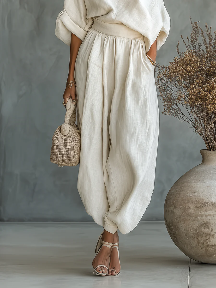 Stylish women's Joanne off-shoulder top & pants set in off-white. Elegant two-piece for spring/summer fashion.