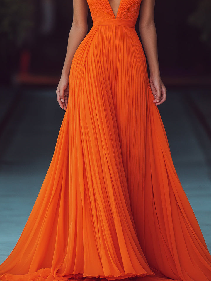 Chic women's orange halter neck maxi dress, featuring elegant V-neckline & delicate pleats for a sophisticated look.