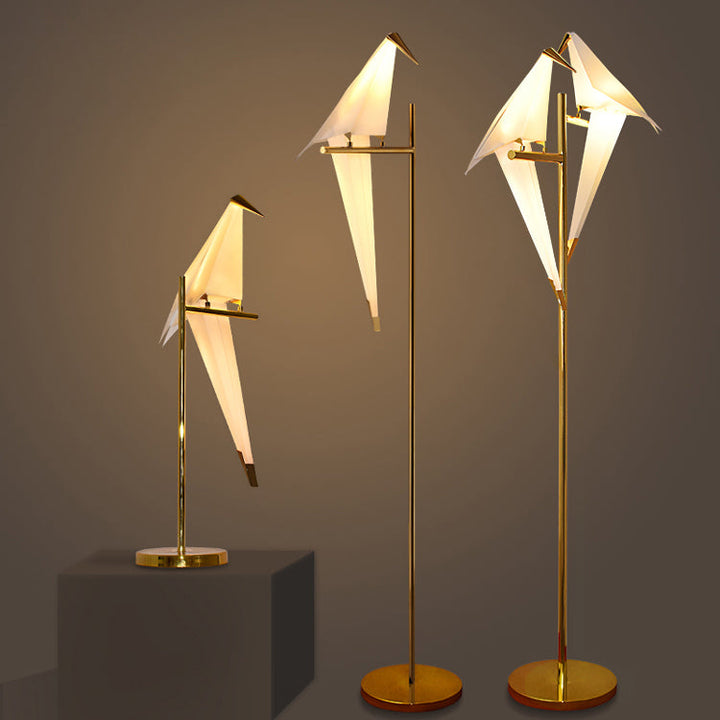 Unique origami bird lamp with a magnetic base, offering flexible and stylish wireless lighting.