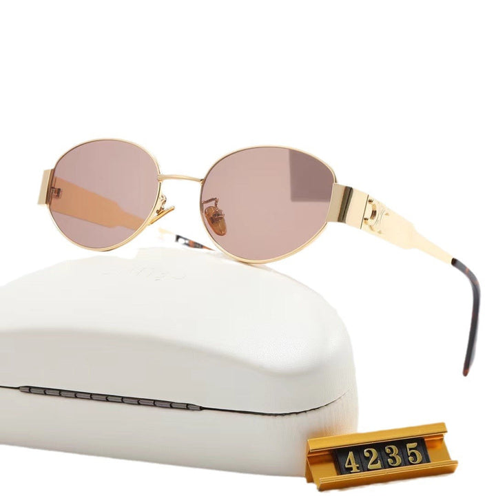 Close-up: Designer oval sunglasses for women. High-quality frame, UV protective lenses.