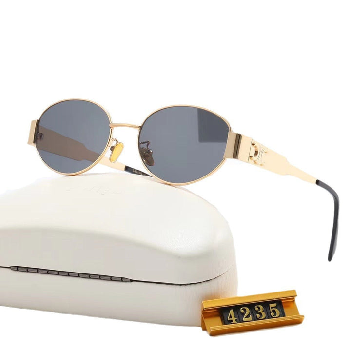 Stylish woman wearing elegant oval designer sunglasses, offering excellent UV protection.