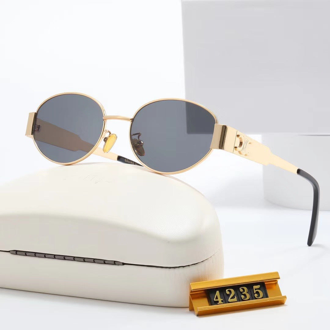 Black frame elegant oval designer sunglasses for women, ensuring chic style & UV protection.