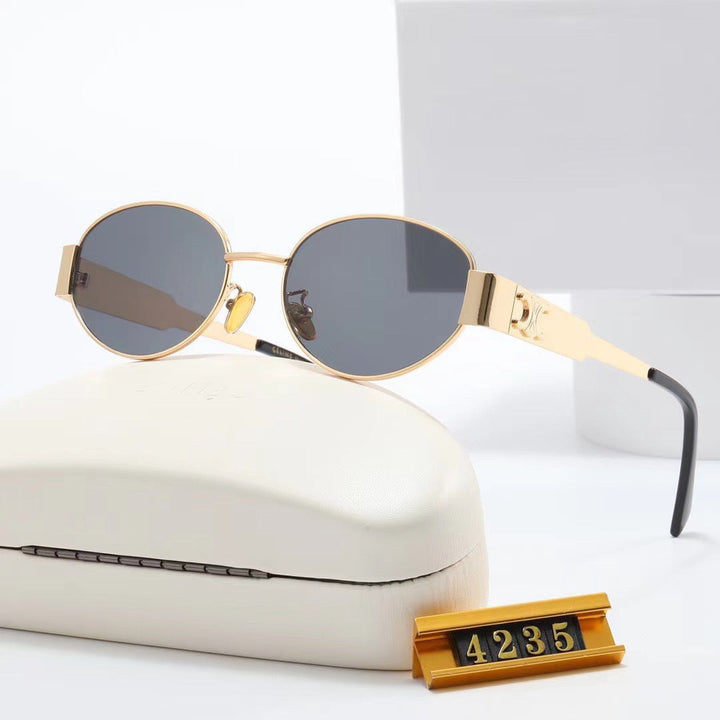 Black frame elegant oval designer sunglasses for women, ensuring chic style & UV protection.
