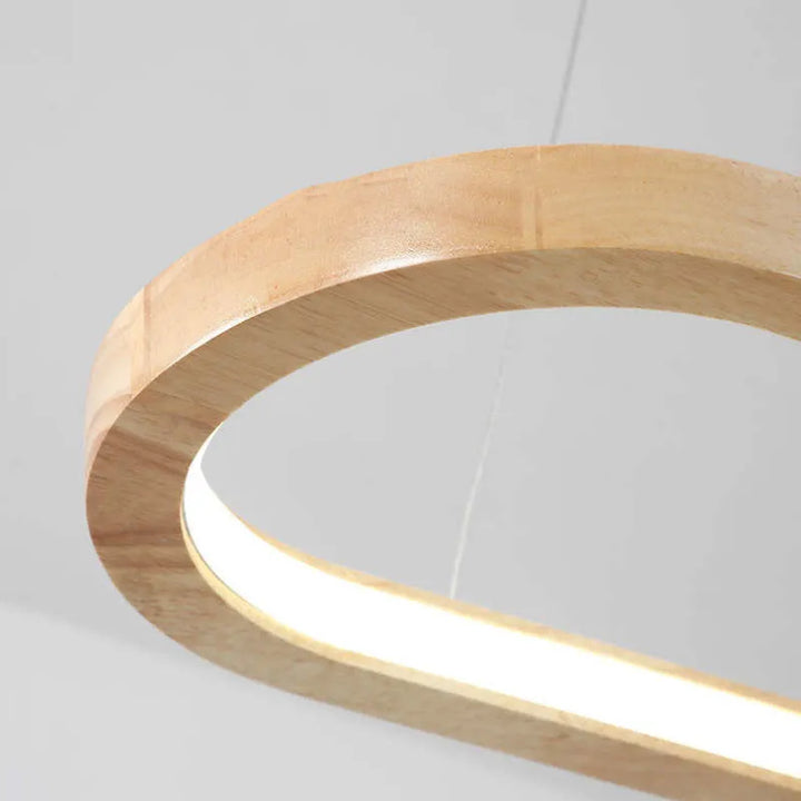 Contemporary wood and acrylic oval pendant, bright LED illumination for dining and living rooms.