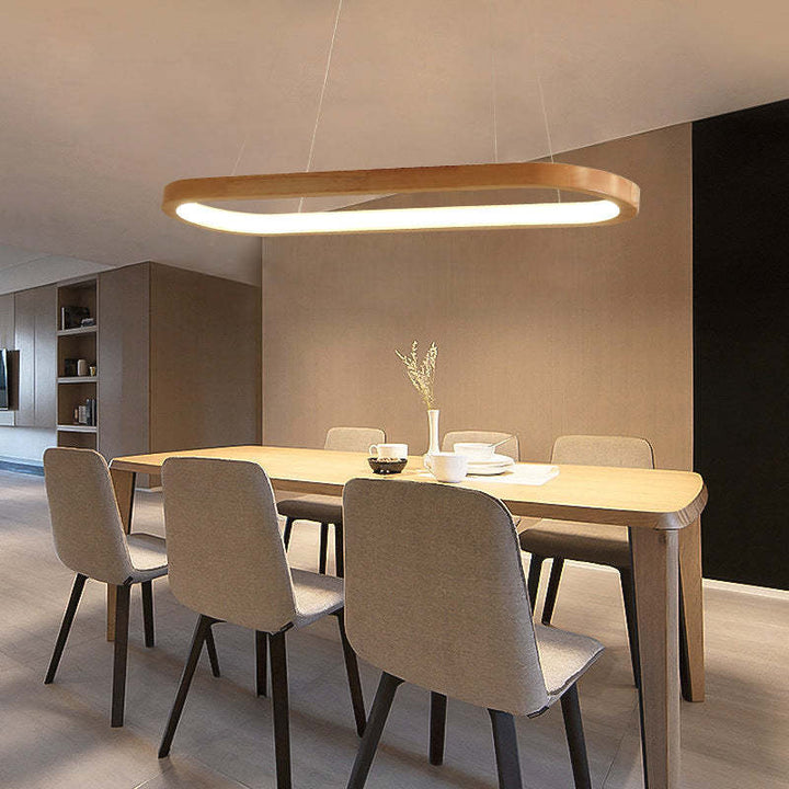Minimalist oval pendant lamp, wood & acrylic construction, brightens any modern interior.