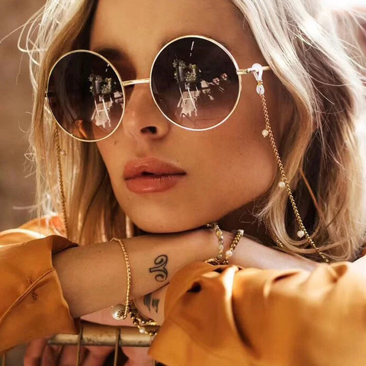 Elegant pearl glasses holder chain for women, securing eyewear in style.
