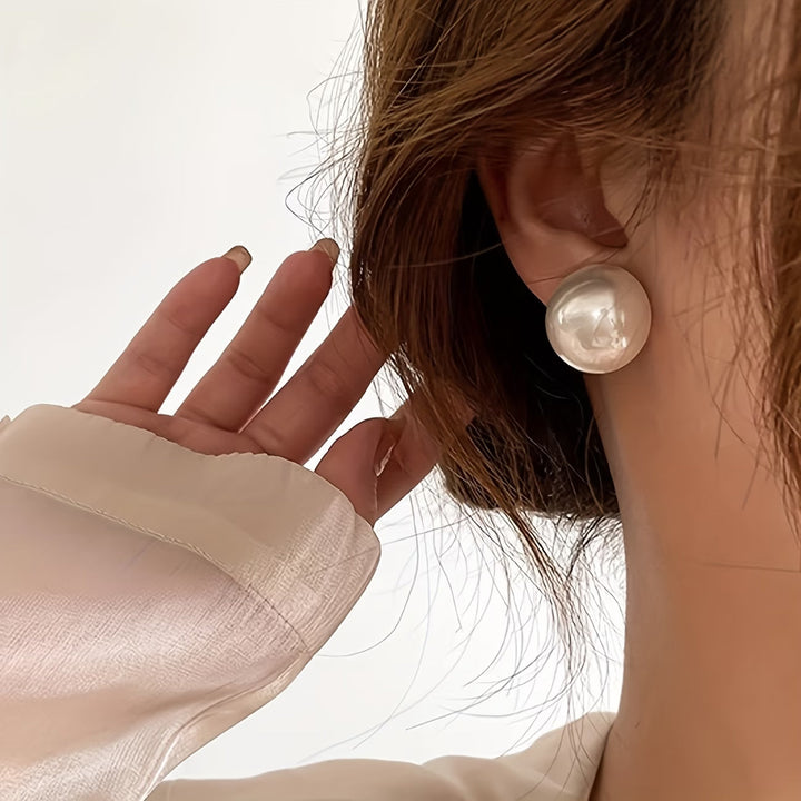 Elegant pearl stud earrings for women, timeless fashion jewelry. Hypoallergenic design, perfect gift.