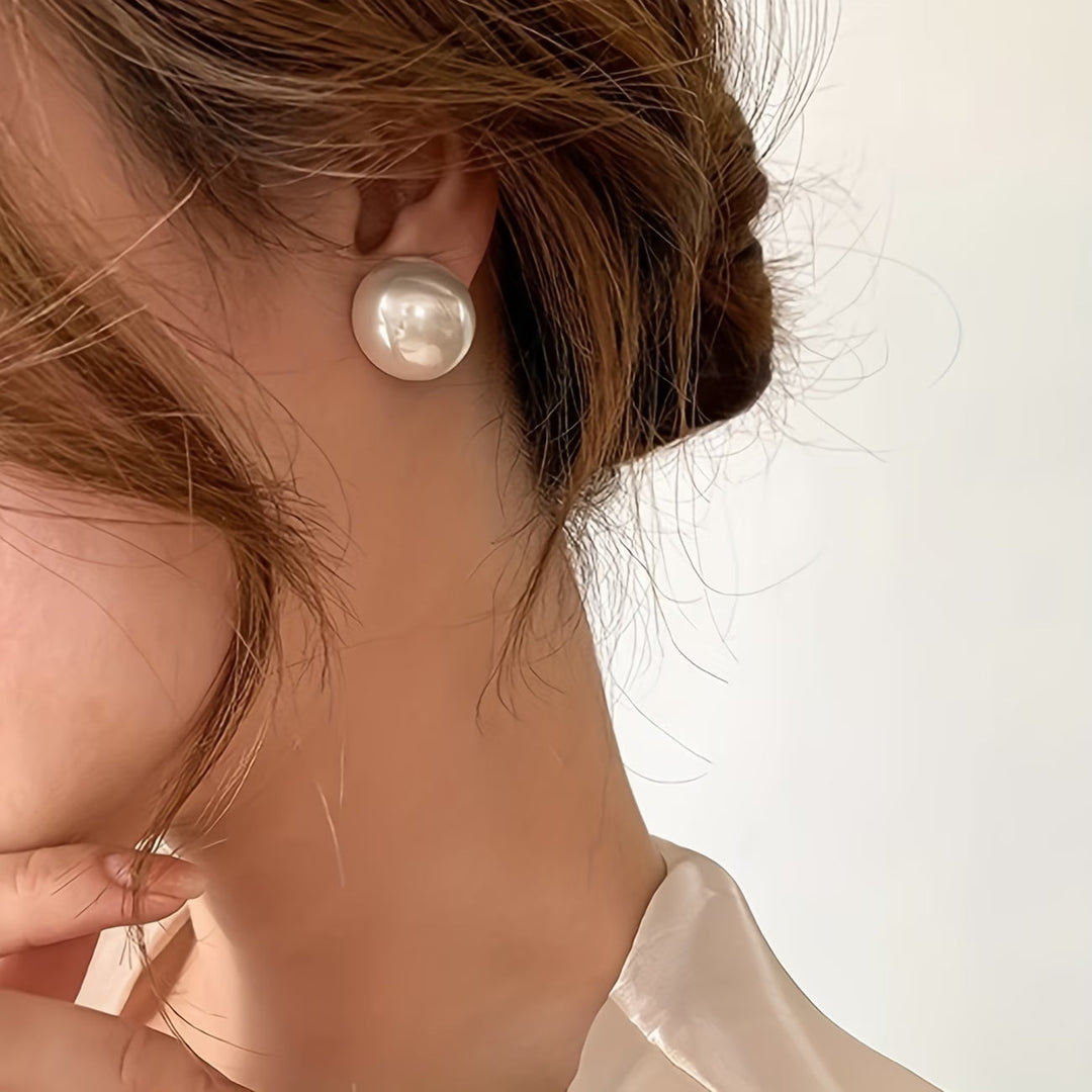 Beautiful hypoallergenic pearl stud earrings, a timeless gift for women. Elegant and versatile fashion jewelry.