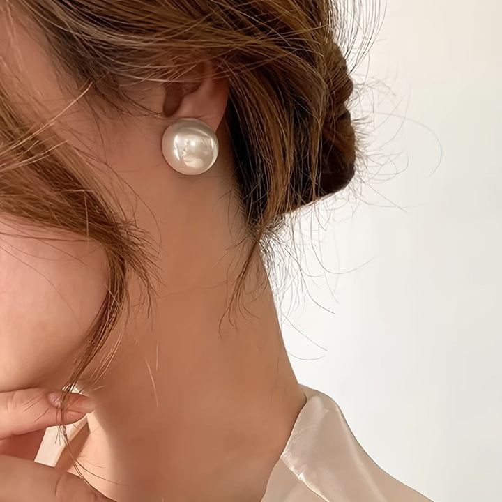 Beautiful hypoallergenic pearl stud earrings, a timeless gift for women. Elegant and versatile fashion jewelry.