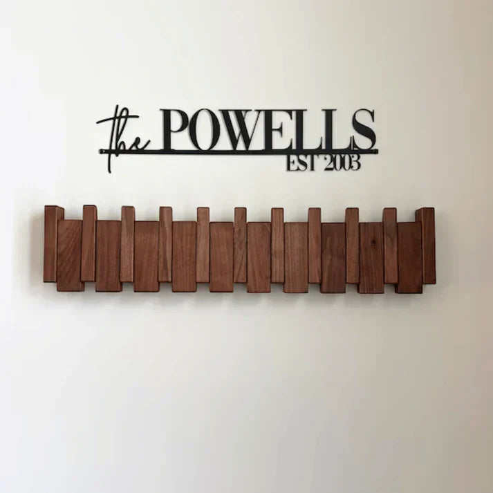 Elegant piano key wall coat rack, perfect for stylish home entryway organization. Multi-hook, space-saving design.