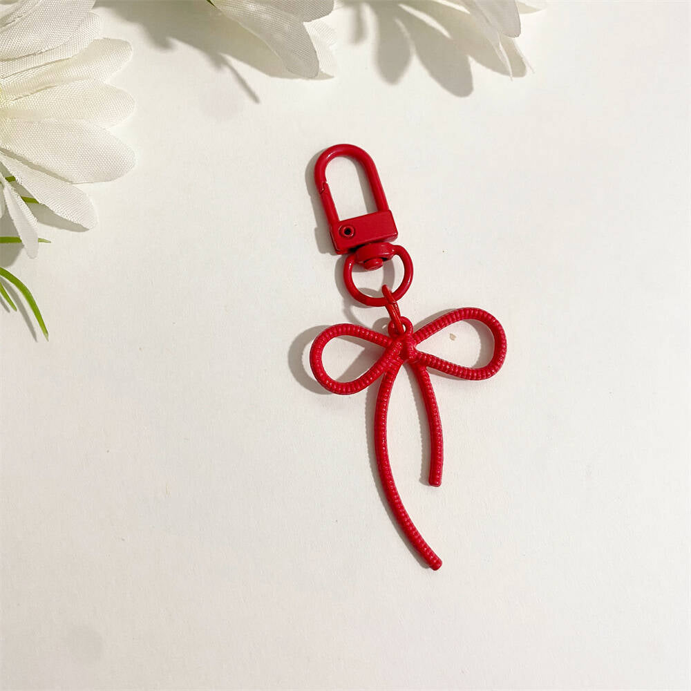 Modern blue bow key ring, a trendy accessory for bags & keys, perfect for women.