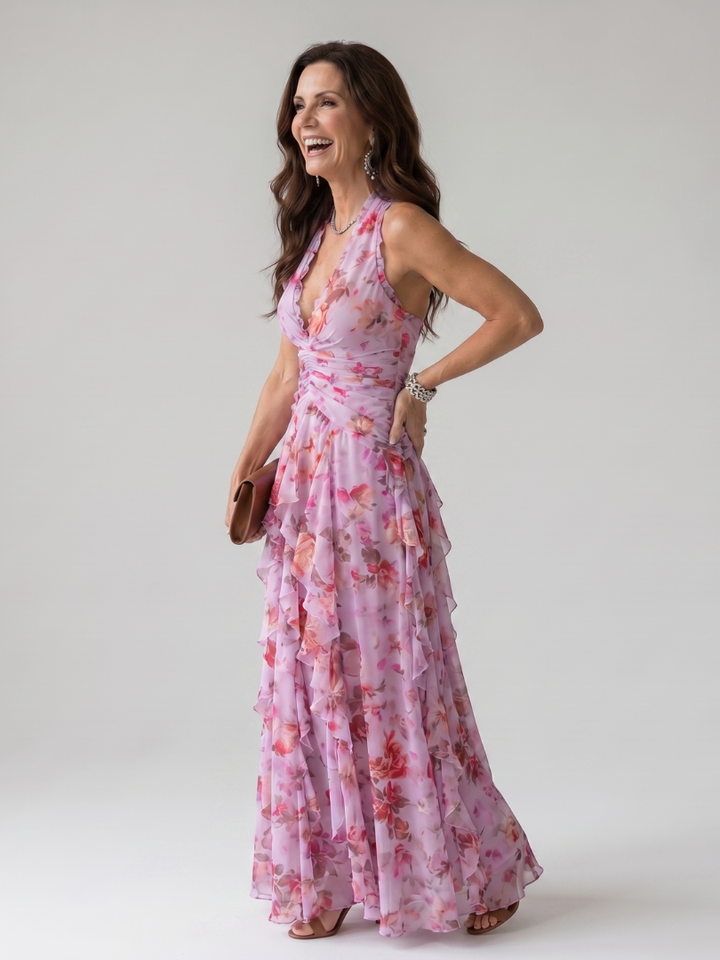 Women's blue halter neck maxi dress, ideal as a wedding guest outfit or elegant evening gown. Flowy formal wear.