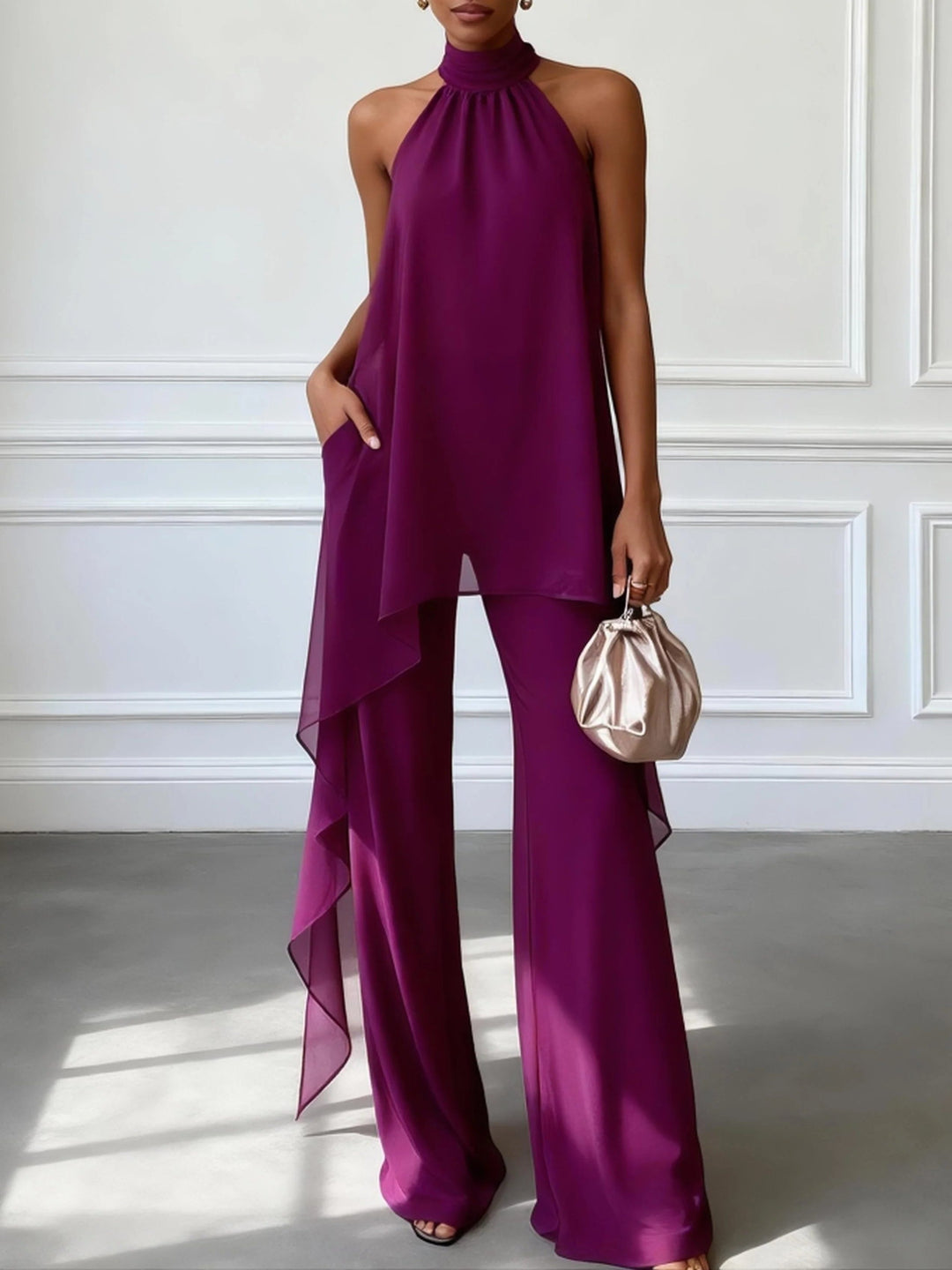 Women's stylish purple halterneck trouser set with wide leg pants. Ideal elegant outfit for evening events.
