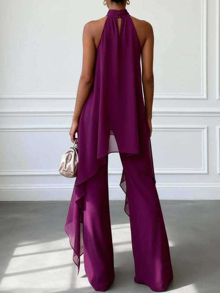 Modern women's purple two-piece halterneck top and wide leg trouser set. Chic co-ord for special occasions.