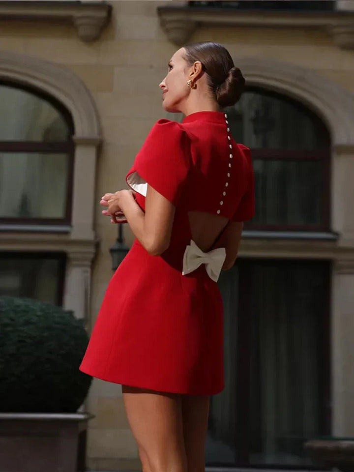 Chic red mini party dress for women, elegant and stylish, with short sleeves and a playful tie detail. Summer.
