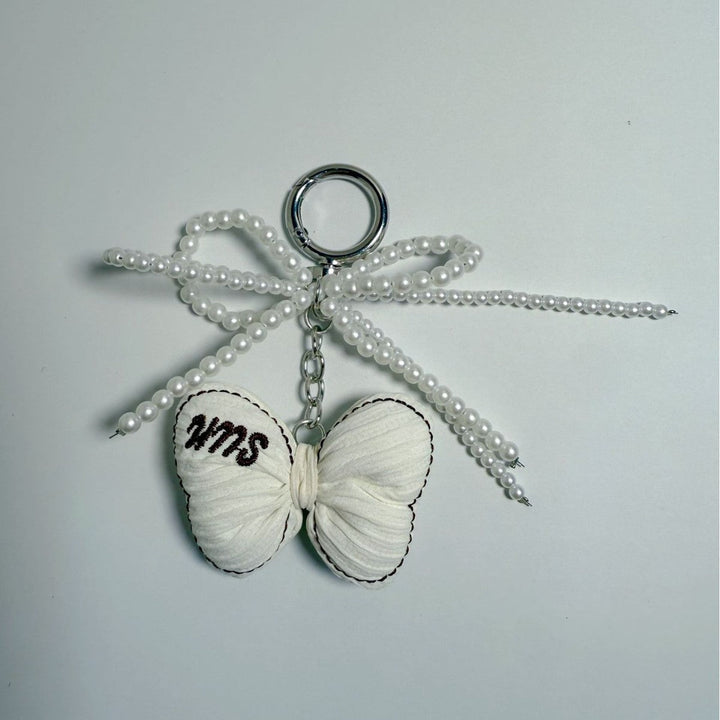 Beautiful butterfly bag charm, women's accessory with pearl and metallic details.