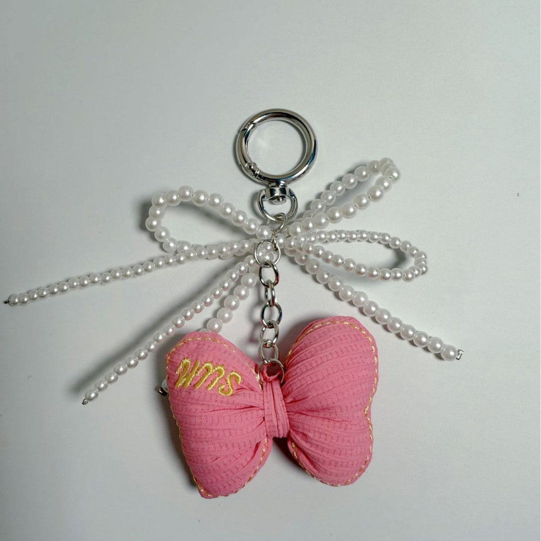 Luxury butterfly keychain with faux pearl, a chic accessory for bags & keys.