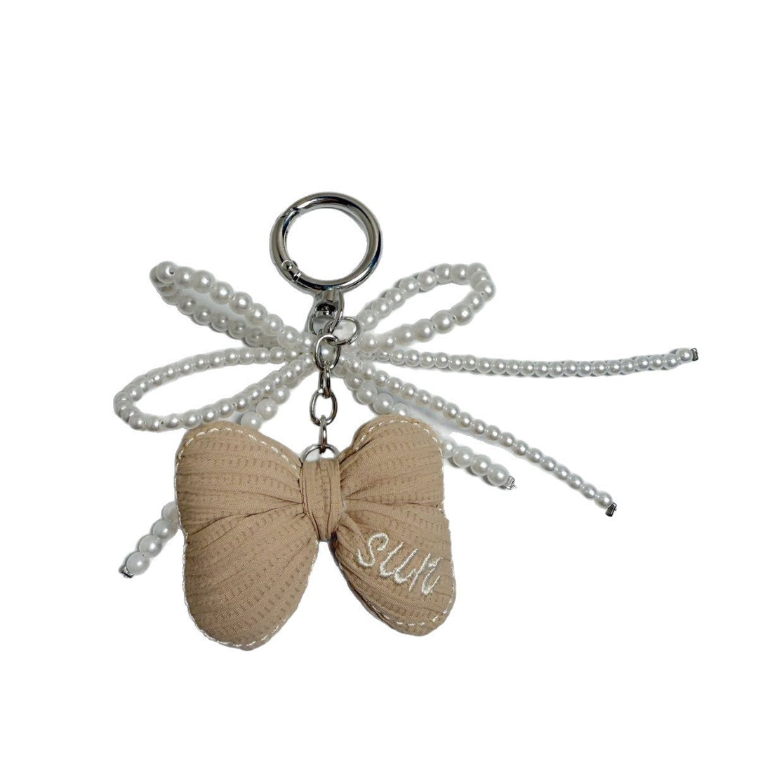 Shiny metallic butterfly charm, an elegant women's key or bag accessory.