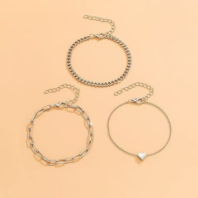 Stylish women's layered chain bracelet set, featuring gold & silver tones for an elegant look.