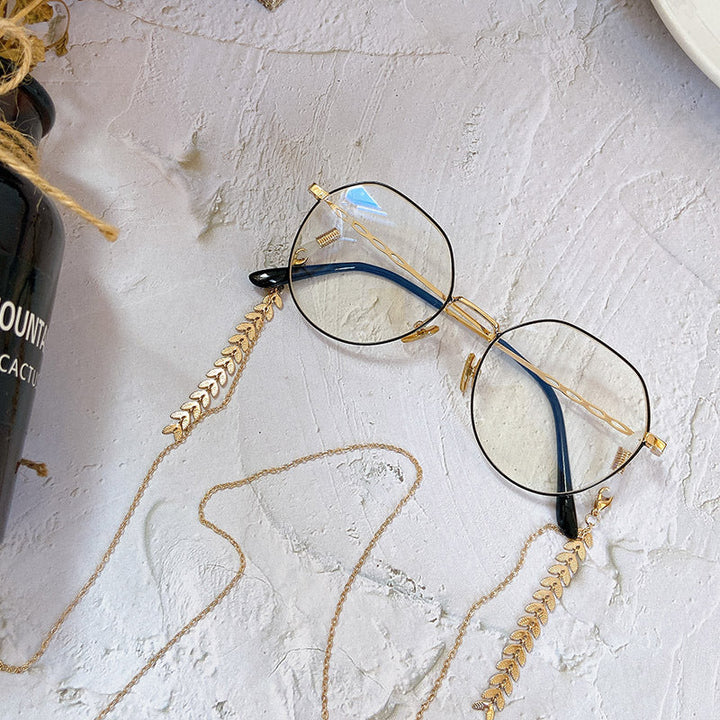 Exquisite gold leaf drop statement earrings for women. Elegant and modern hypoallergenic jewelry accessory.