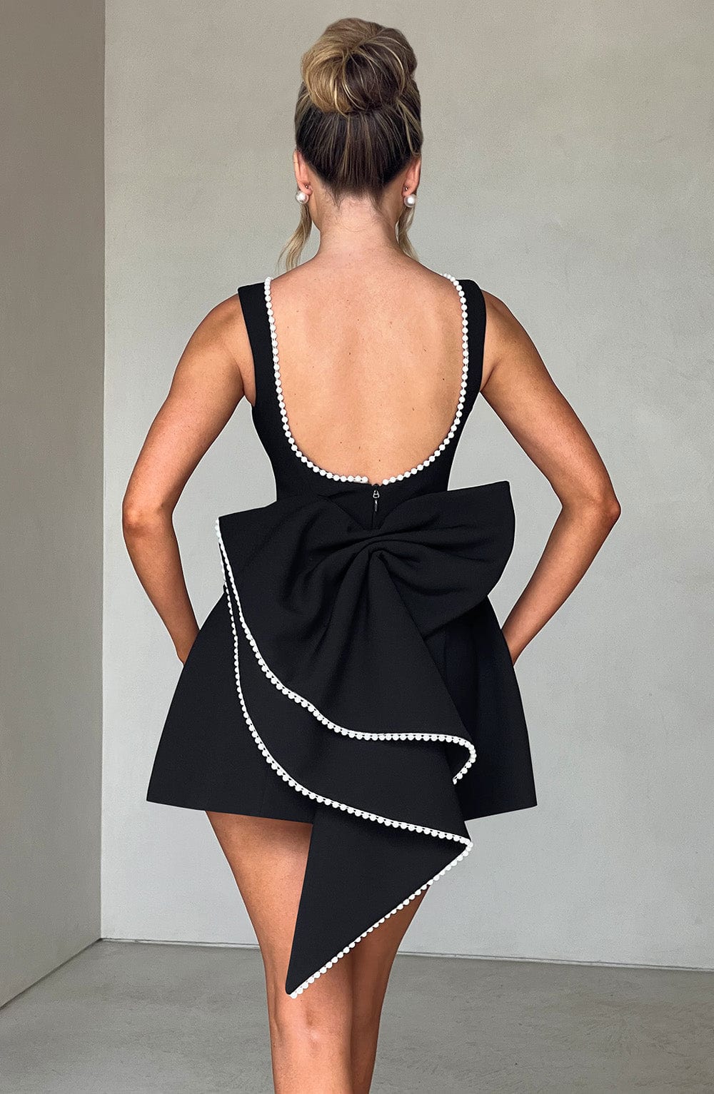 Women's elegant sleeveless mini dress, perfect party wear & formal attire for wedding guests.