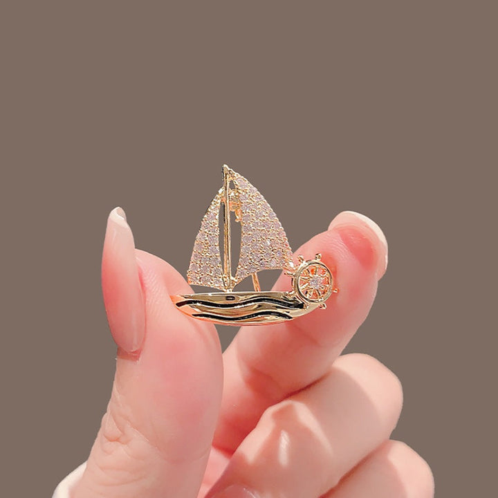 Shimmering crystal sailboat pin, an elegant women's nautical jewelry accessory.