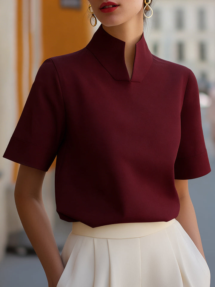 Stylish women's work blouse featuring a stand collar & short sleeves, a professional office top.