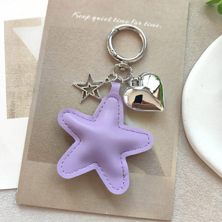 Unique star & heart keychain in faux leather and metal, a stylish and practical gift idea.