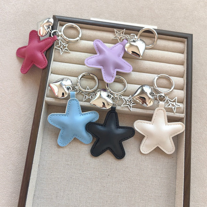 Stylish metal & faux leather star and heart keychain, an elegant charm for bags and keys.