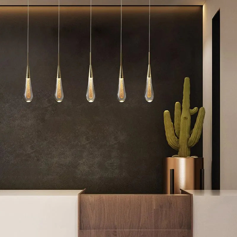 Shimmering teardrop crystal pendant light, elegant LED ceiling fixture.