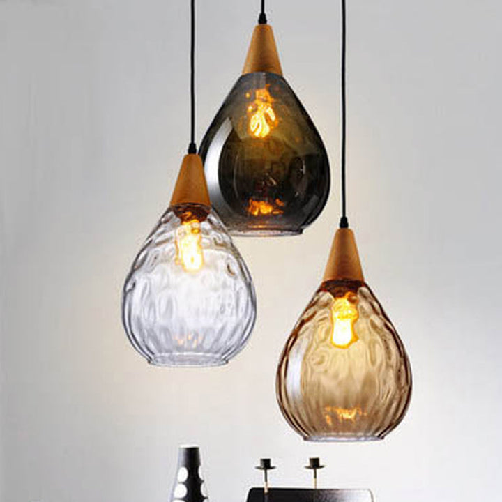Modern elegant teardrop glass pendant light, perfect hanging lamp for living room decor.
