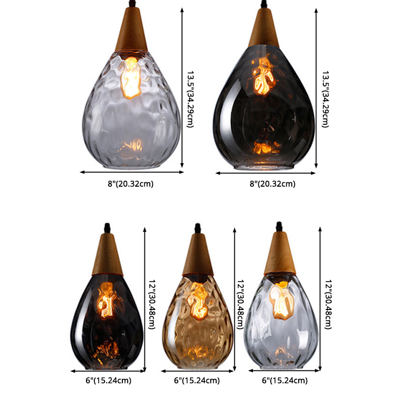 Teardrop glass pendant light with warm wood top. Chic modern ceiling lamp for dining rooms.