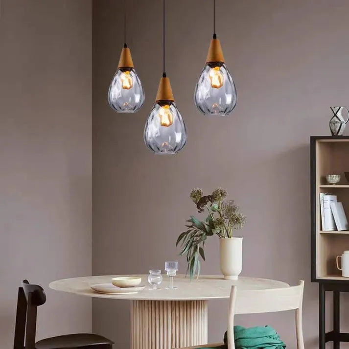 Elegant teardrop glass pendant lamp, perfect dining room lighting, clear glass design.