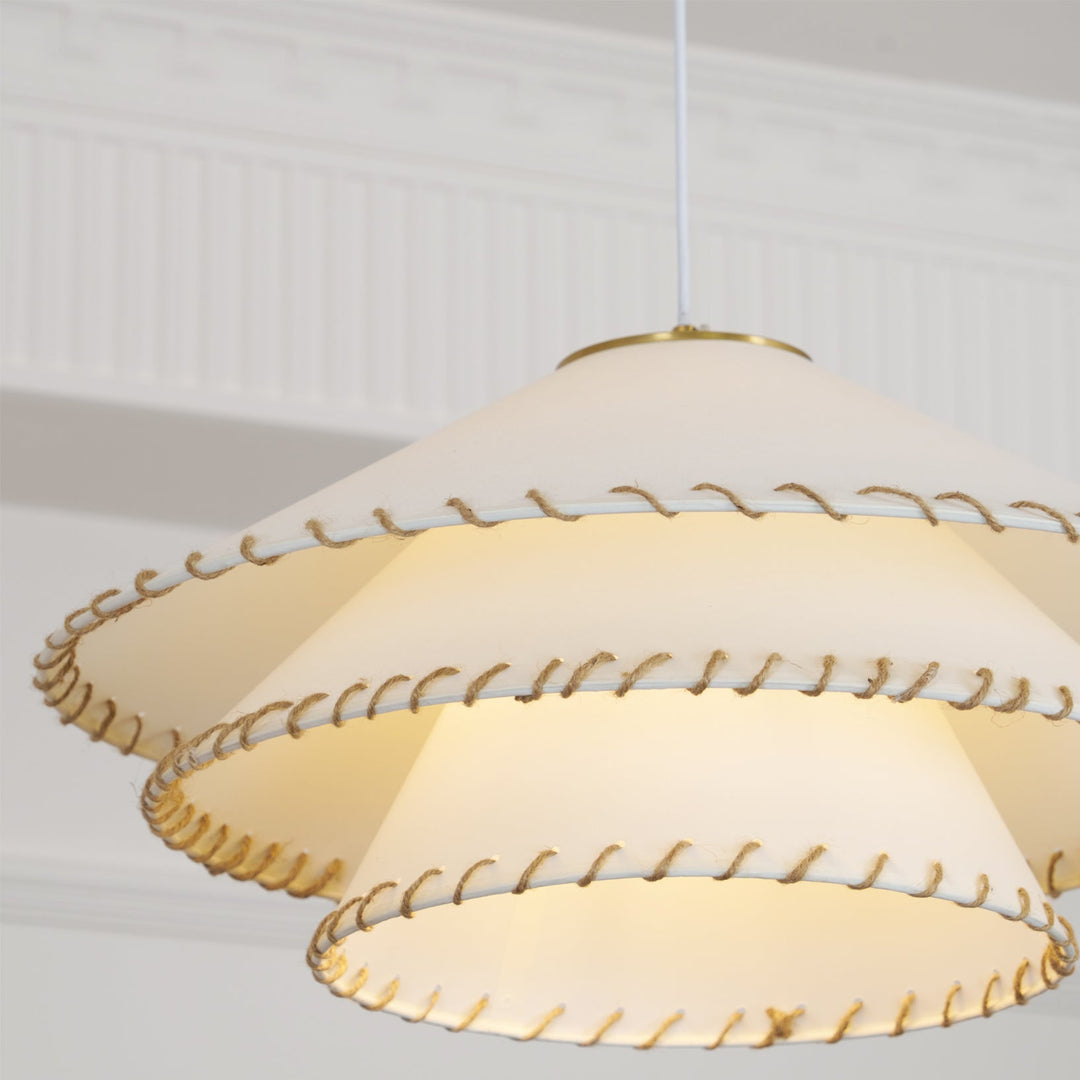 Contemporary tiered pendant light, casting warm ambient light in an elegant space.