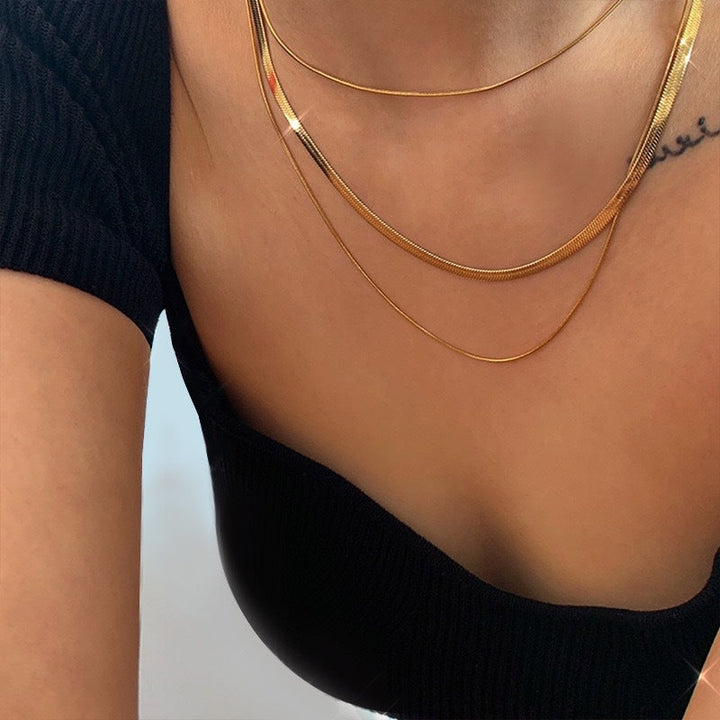 Chic women's triple layered chain necklace, gold tone stainless steel. Fashionable and durable accessory.