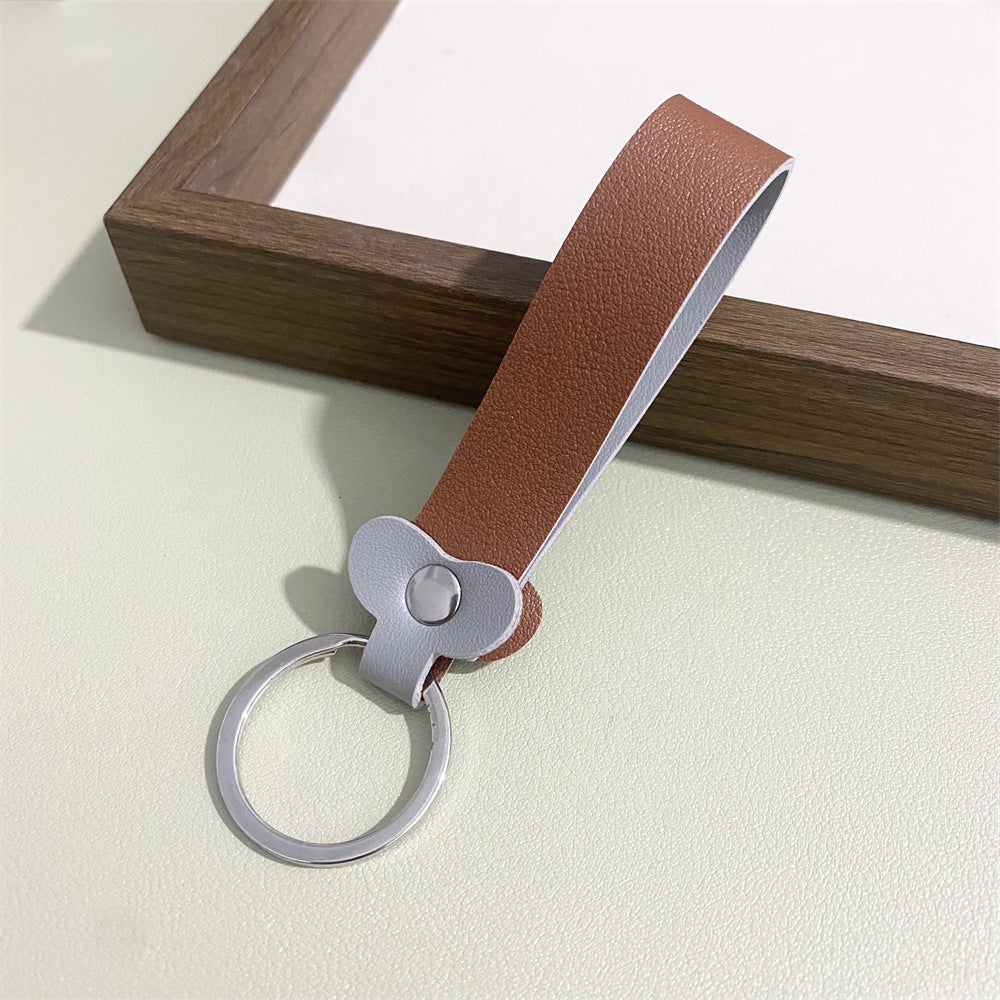 Artisan-designed floral leather key organizer and elegant bag accent.